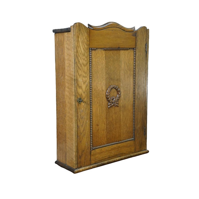 This exceptional antique solid oak medicine cabinet combines a finely detailed classical exterior with a highly...