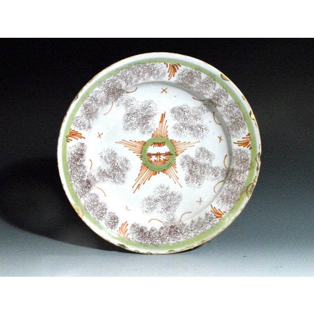 Bristol Delftware Star Dish with Sponged Manganese Clouds, English, Circa 1745 This Bristol delftware shallow dish, made...