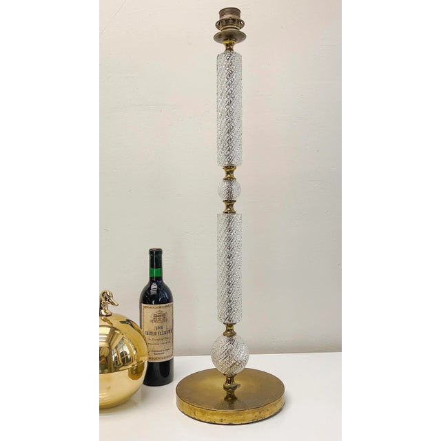 A stunning and rare tall column table lamp of cut glass with brass. Very beautiful chic classic design, one of a kind. The...