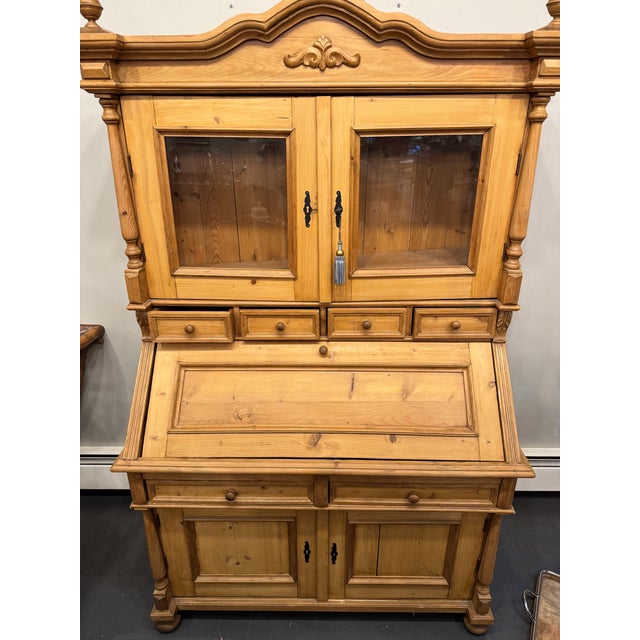 This is an Antique Danish Country Pine Secretary. It has two sets of doors to open for storage with a key to lock them. It...