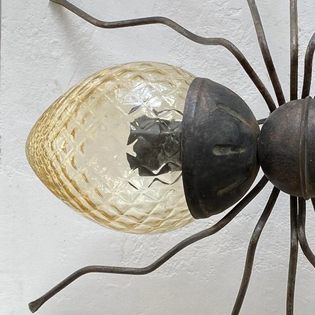 Mid-century Italian Metal & Glass Spider Wall Lamp in the shape of a spider. Body made of wrought iron and yellow glass....