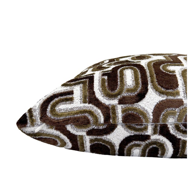 This pillow showcases a layered blue velvet design on a textured white bouclé background, combining depth with softness....