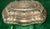 Beautiful vintage-style silver-tone decorative trinket box featuring an ornate raised floral design and scalloped edges....
