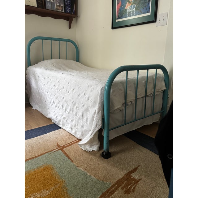 Charming Vintage teal metal bed frame. Classic iron rod design with a curved headboard and footboard. Great character and...