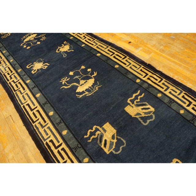 Antique Chinese Peking Blue Allover Floral Knotted Hallway Runner Rug, Circa Date: 1900s. This exceptional example of...