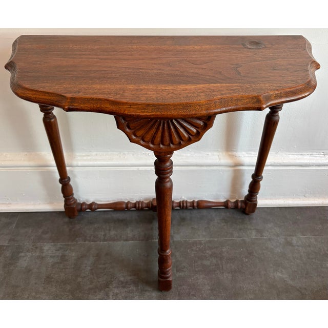 Small antique demi lune table with shell detail. At 21" high, it's the perfect height to display a plant or a vase. The...