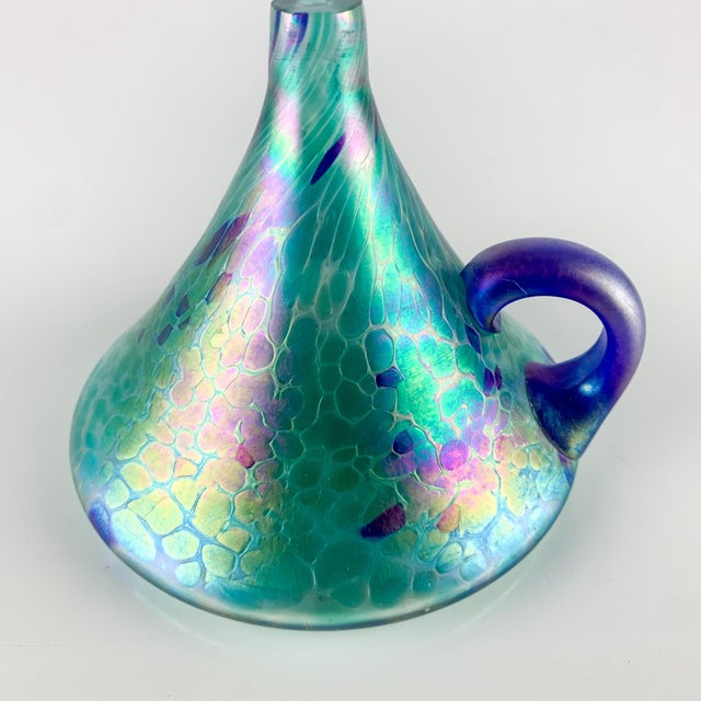 Gorgeous vintage hand blown glass oil lamp with finger loop handle. Love the iridescent swirls of blue and green. Great...