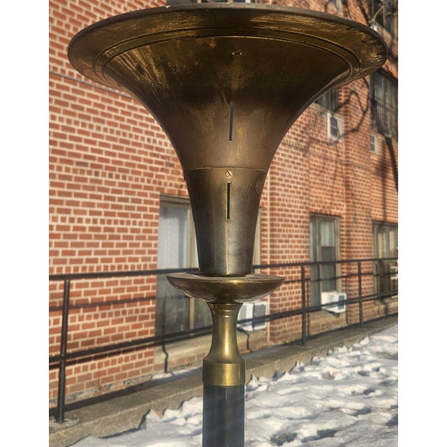 Art Deco Torchiere Brass Floor Lamp The solid brass shade is a pierced trumpet with a rim with small rectangles, and...