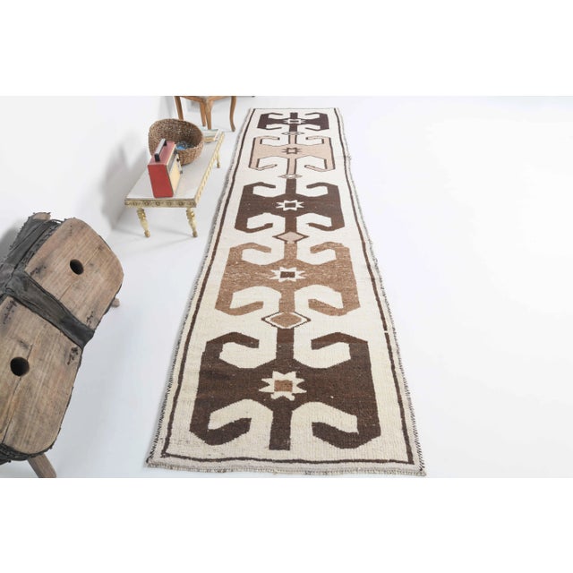 Vintage Turkish Hand-Knotted vintage rug is a semi-Vintage runner rug.'70s Eastern region of Turkey's unique rug is...