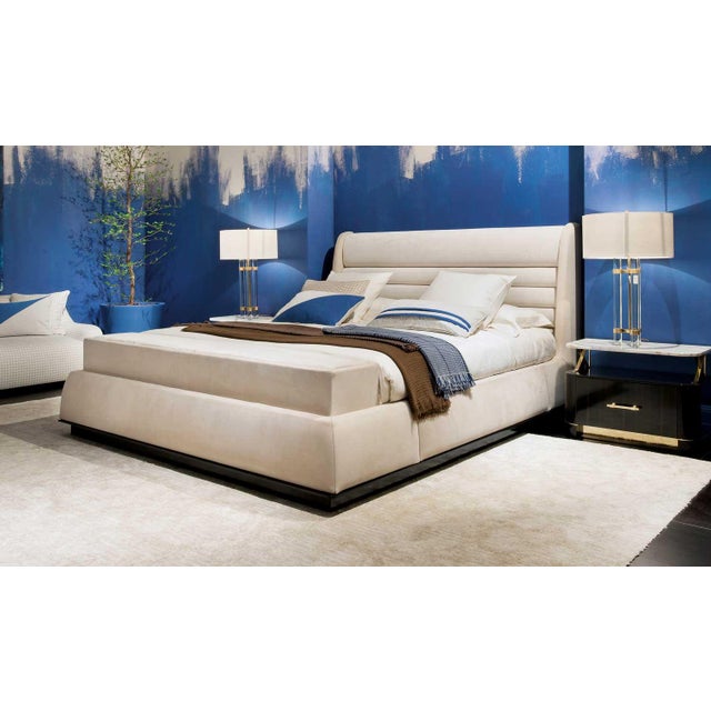 Handcrafted in Italy, this king bed features a fully upholstered headboard and frame in a combination of velvet and nubuck...