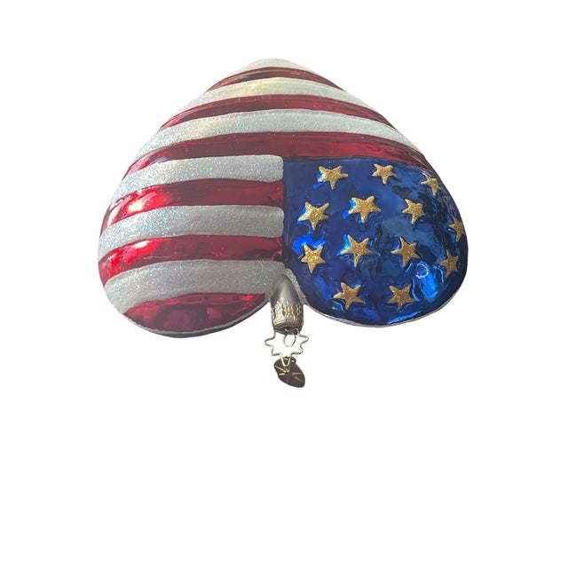 This vintage 2001 Christopher Radko Brave Heart American Flag Christmas Ornament is a stunning addition to any holiday...