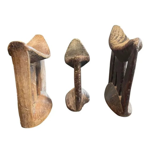 Carved wooden headrests from Ethiopia. Used by the Arussi people as a means of protecting elaborate hairstyles while...