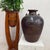 "About This Piece About This Piece Evoking the quiet strength of ancient craftsmanship, this earthenware jar is hand-...