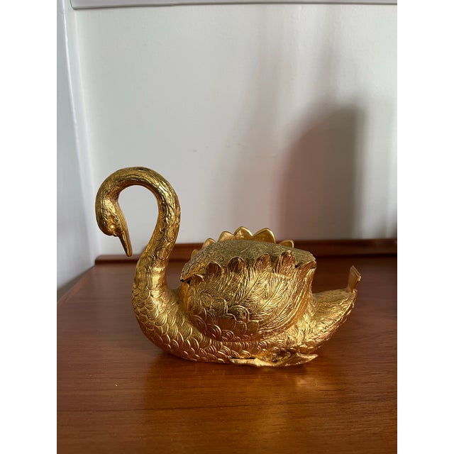 The swan is made of metal with a beautiful gilt finish. The back is hinged and the roll of tape is concealed in the...