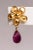 A lovely 22K gold flower post earring with a pear-shaped, faceted pink tourmaline briolette drop. For pierced ears. The...