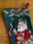 Classic 1990s Christmas stocking made in wool needlepoint, red velvet back and cording. The needle work depicts a pipe-...