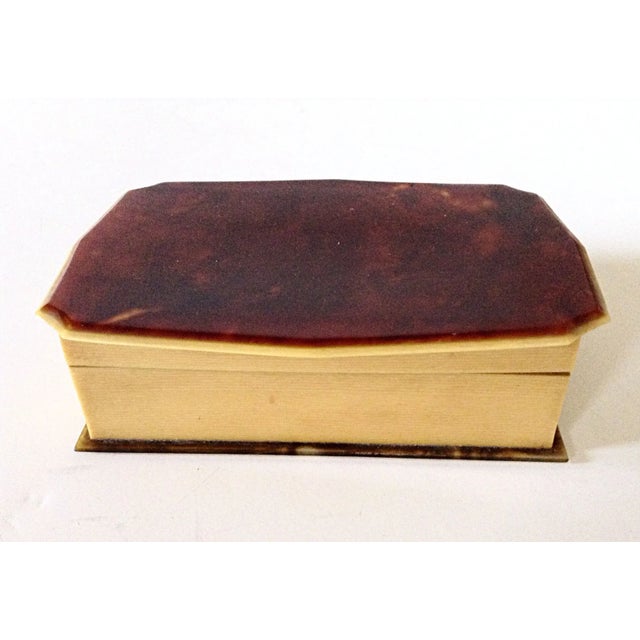 This celluloid jewelry box is lined with a cocoa colored velvet and has a faux tortoise shell top and bottom.
