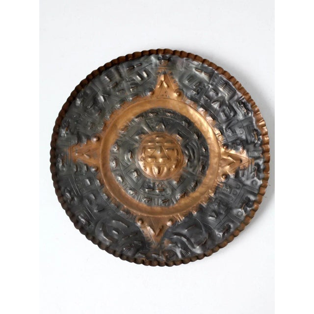 This is a mid-century decorative copper plate. The large hammered copper plate pictures the Sun god Aztec calendar. Great...