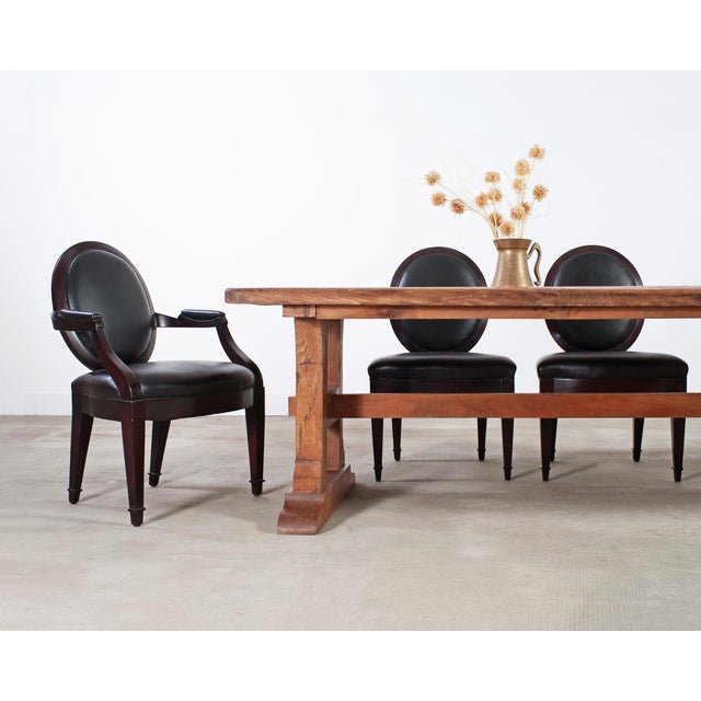 Substantial set of ten "Grand Soleil" black leather and mahogany dining chairs designed by John Hutton for Donghia. The...