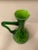 Very unusual pattern of a classic mid century cased glass pitcher. The handle is clear green glass with the body of the...