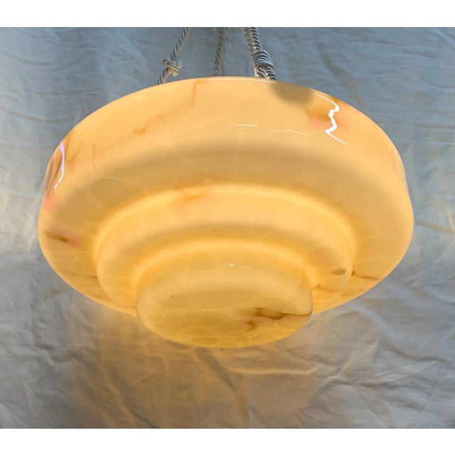 Pendant lamp composed of an alabaster-effect glass lampshade, amber yellow in color with marbled veins. The glass has a...