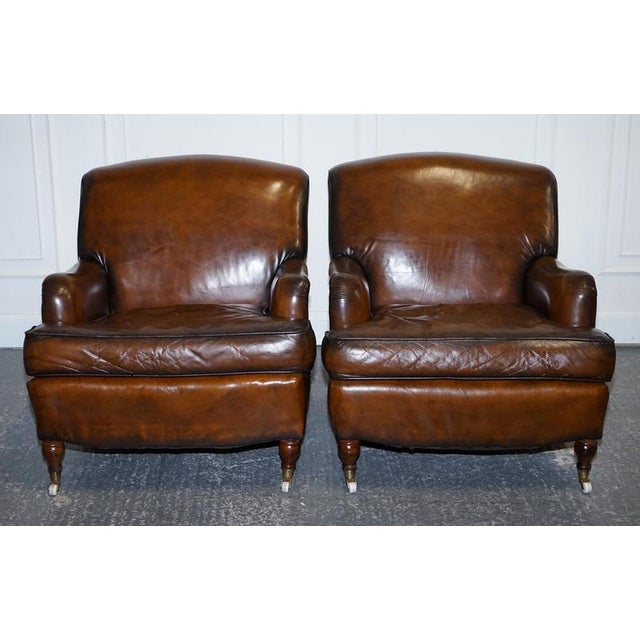 Howard & Sons style leather armchairs, expertly hand-dyed using traditional techniques for a rich, heritage finish....