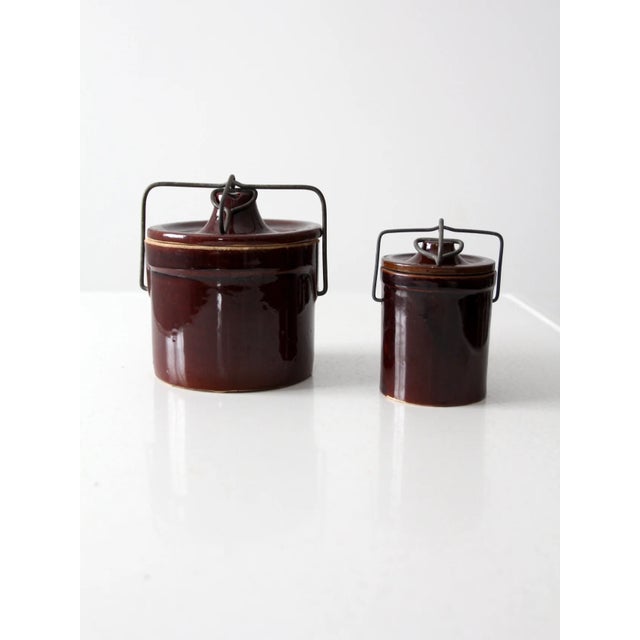 This is a pair of vintage stoneware preserve jars. The brown ceramic jars feature bail locking lids. A great pair for...