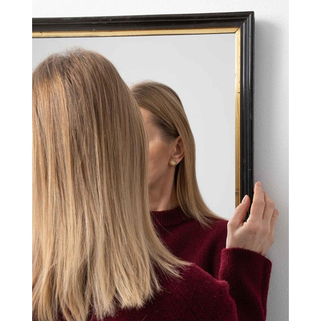 This mirror makes its impression through black/gold thin frame, square. The piece dates to 19th Century, sourced from...