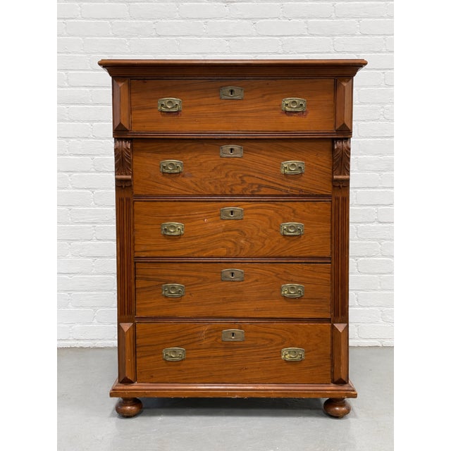 Handsome antique Danish pine chest with five spacious drawers, warm amber-brown tones, and an expressive grain pattern....