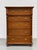 Handsome antique Danish pine chest with five spacious drawers, warm amber-brown tones, and an expressive grain pattern....