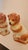 This listing features a pair of ceramic Staffordshire Spaniels with gold detailing and glass eyes. These guarding dogs...