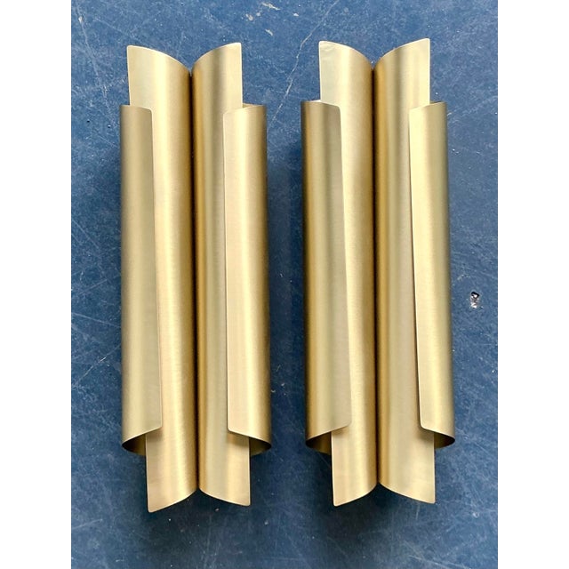 These stunning "Cyrus" wall light sconces by Brabbu exemplify contemporary luxury with a distinct architectural edge....