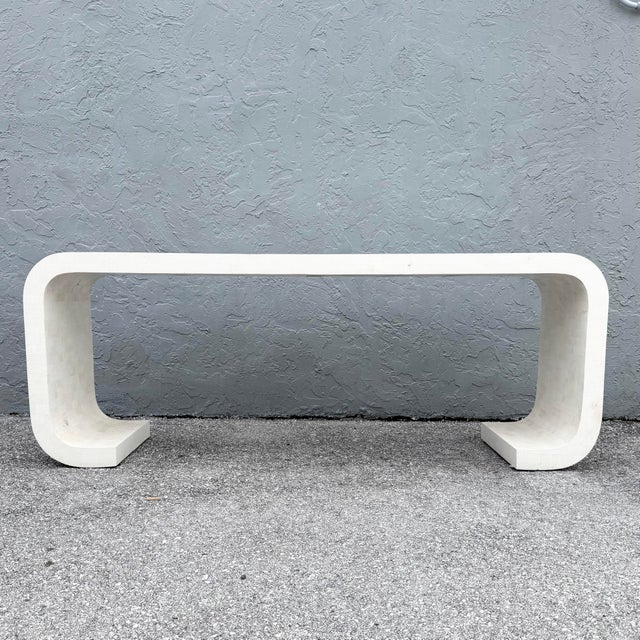 This postmodern console table by Maitland Smith combines a sculptural waterfall silhouette with the subtle texture of...