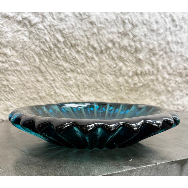 Ribbed pressed glass round ashtray designed by Wayne Husted for the Blenko Glass Company. The model number is 6112S and...