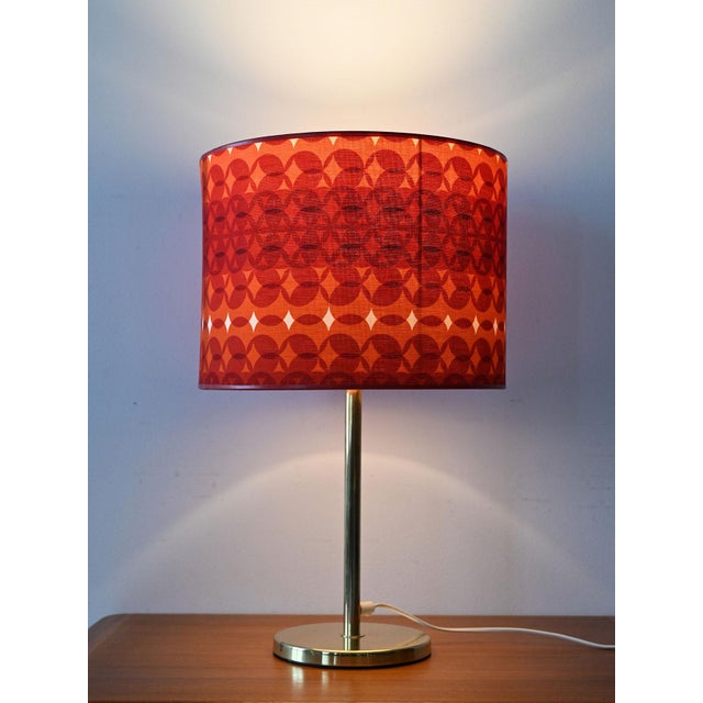 Table lamp produced by Aneta with a brass base and original 1970s geometric fabric lampshade. Swedish table lamp from the...