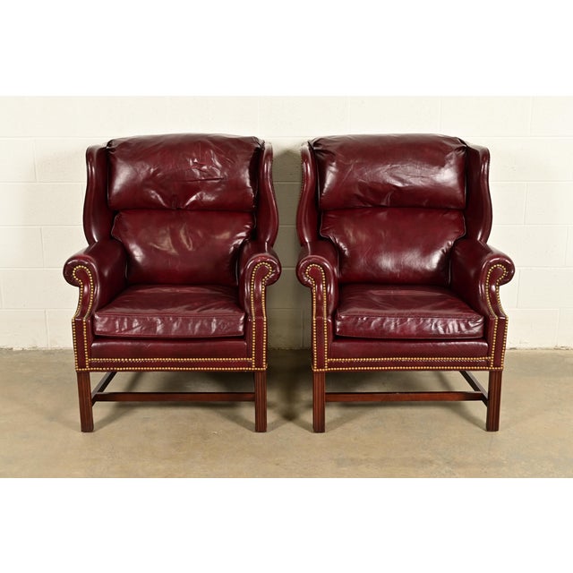 A gorgeous pair of Chippendale style wingback library chairs, lounge chairs, or fireside chairs By Hancock & Moore USA,...