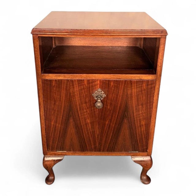 This vintage walnut cabinet is a stunning 1940s Art Deco furniture piece designed to provide elegant vinyl record storage...