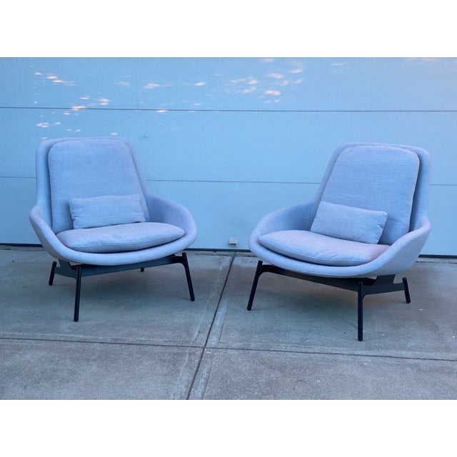Pair of Field Lounge Chairs by Blu Dot, which feature sculpted steel and bent wood shell, plush foam padding, and a...