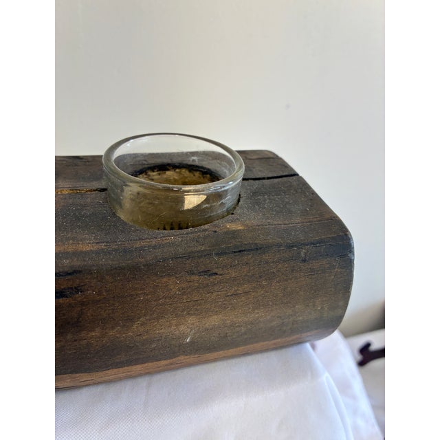 This vintage wooden candle holder features a solid wood block construction with three glass candle inserts. The aged wood...