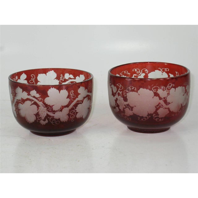 This product is a set of four ruby flashed Bohemian glass bowls with engraved copper wheel grape leaf design. The antique...