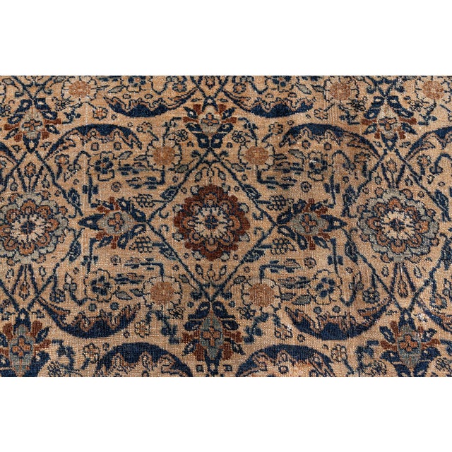 This circa-1880 antique Northwest Persian Tabriz rug features an all-over design of palmettes, serrated leaves and floral...