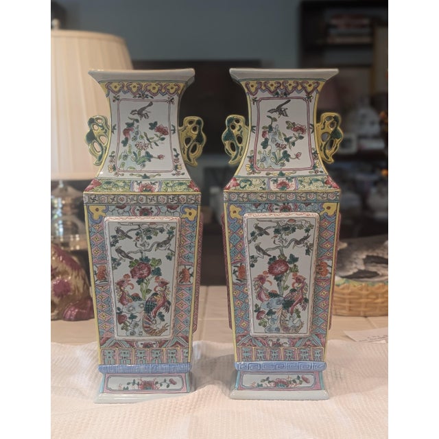 A rare pair of antique Chinese export vases. Exquisitely detailed scenes depict two phoenix birds perched in a tree...