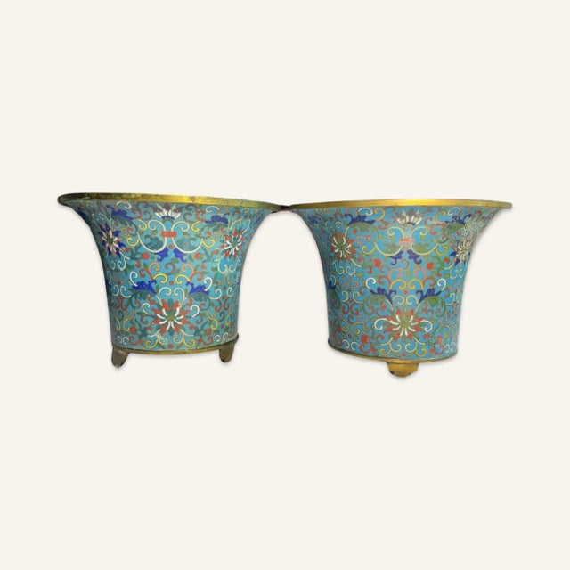 Pair of Ming Dynasty cloisonné censers with copper bodies and gilt copper rims and feet. The design in the cloisonné...