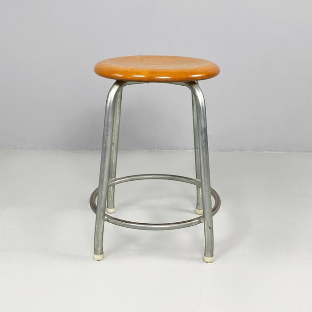 Italian mid-century modern Wooden and metal stool by Embru, 1960s Stool with wooden round seat and rounded profiles. The...