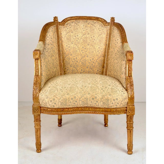 A lovely example of a traditional French bergere updated with a Fortuny hand printed upholstery fabric. Original gilding...