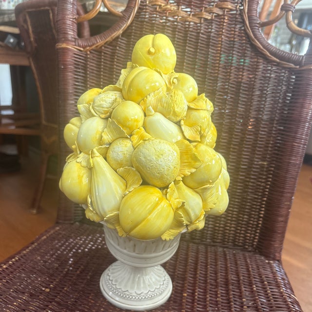 This vintage Italian Majolica ceramic lemon topiary centerpiece features a hand-painted yellow fruit pyramid arranged in a...