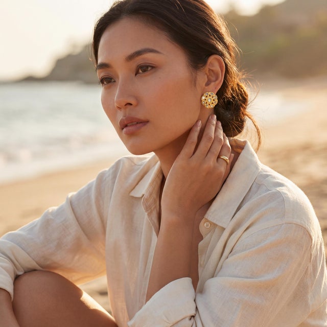 A pair of vintage high karat gold and rose cut diamond earrings from India. The design showcases a floral motif with gold...