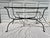 A single vintage rectangular metal outdoor dining table base featuring Salterini style accents including leaves and...