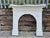 A handsome antique victorian cast iron arched fireplace surround, distinguished by its elegant architectural form,...