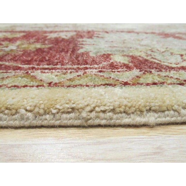 This hand knotted pile rug features a primary color palette of ivory, beige, cream, and white. Crafted from wool, this...